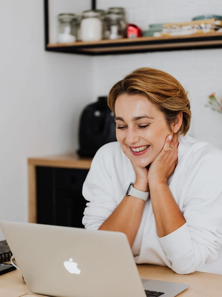 A woman smiling while connecting online from home